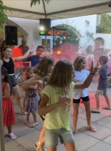 a group of children dancing in front of a fountain at ZEcamping 2 étoiles accès direct à la plage chiens acceptés piscine in Ghisonaccia