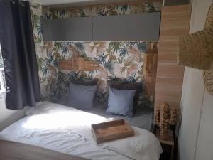 a bed with a wooden box on top of it at ZEcamping 3 étoiles avec piscine chauffée - bar et restaurant in Pézenas