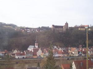 a town with a castle on top of a hill at Monteurpension Haus Monika in Marktheidenfeld