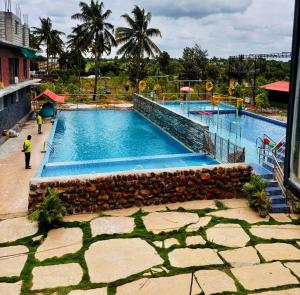 a large swimming pool in a resort at Nature's Resort in Kaivār