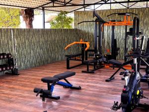 a gym with several exercise bikes on a wooden floor at Nature's Resort in Kaivār
