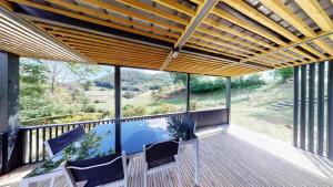 a view from the deck of a house with a view at ZEcamping 4 étoiles animaux acceptés tennis piscine couverte in Vic-sur-Cère