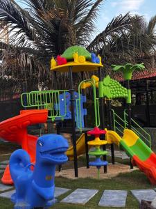 a playground with different colored slides in a park at Nature's Resort in Kaivār +10 photos