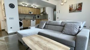 a living room with a couch and a table at Apartament DARSENA B 2-2 in L'Estartit