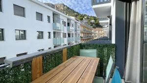 an apartment balcony with a wooden table and chairs at Apartament DARSENA B 2-2 in L'Estartit