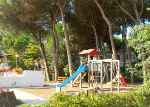a playground with a slide and a swing set at Residence Sporting in Rosolina Mare