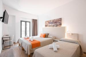 a hotel room with two beds and a tv at Hotel Florencio Ibiza in San Antonio +66 photos