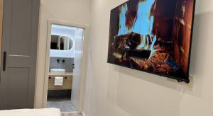 a television hanging on a wall in a bathroom at Hotel zur Post Dabringhausen - Quiet Business Hotel near Cologne and Dusseldorf Trade Fairs in Wermelskirchen