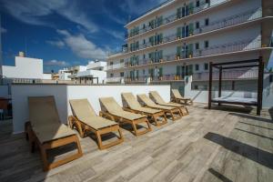 a row of chairs on the roof of a building at Hotel Florencio Ibiza in San Antonio