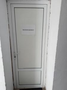 a white door with a sign on it at Berta Gardens 2 in Sandanski