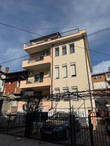 a tall building with a fence in front of it at Berta Gardens 2 in Sandanski
