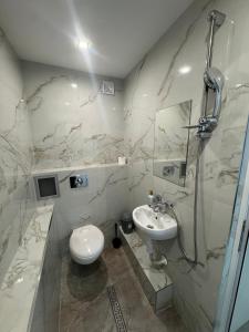 a white bathroom with a sink and a toilet at Berta Gardens 2 in Sandanski +9 photos