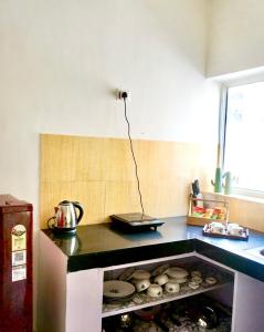 a kitchen with a counter top with some food at Indran in Chhatikara