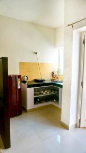 a kitchen with a black counter in a room at Indran in Chhatikara +15 photos