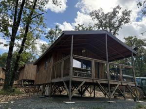 a large wooden house with a gambrel roof at Camping 3 étoiles - Piscine - ccbfa0c in Saint-Mandé-sur-Brédoire
