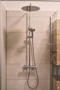 a shower with a shower head in a bathroom at Gästewohnung Schöningen in Schöningen