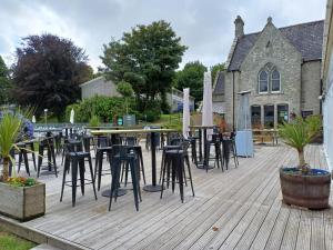 a bunch of tables and chairs on a wooden deck at Sunny holiday house in Newquay