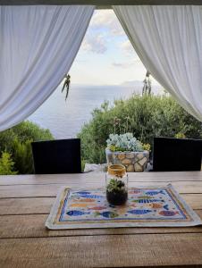 a table with a glass jar on top of a table at House on Punta in Vela Luka +32 photos