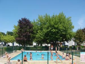 a group of people playing in a swimming pool at CAMPING LE SAILLET Lestelle Betharram in Lestelle-Bétharram