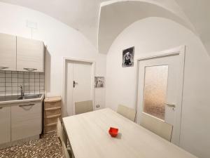 a kitchen with a table with a red box on it at Scorcio Sul Mare in Gallipoli