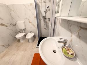 a bathroom with a sink and a toilet at Scorcio Sul Mare in Gallipoli
