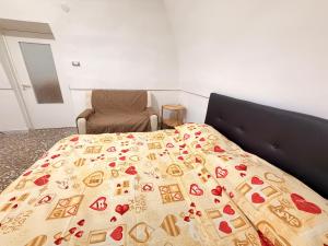 a bedroom with a bed with a blanket on it at Scorcio Sul Mare in Gallipoli