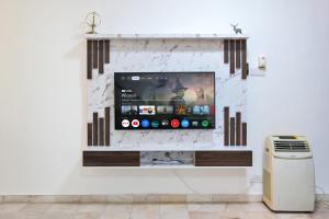 a tv on a wall in a room at Gathering Double Storey House-10pax in Kampong Pantai Batu Hitam
