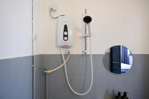 a shower in a bathroom with a mirror at Gathering Double Storey House-10pax in Kampong Pantai Batu Hitam +74 photos