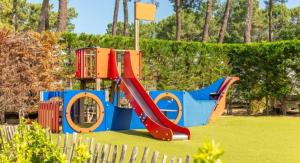 a playground with a slide in a park at ZEcamping 5 étoiles avec piscine chauffée dog friendly sauna tennis 3km plage in Vieux-Boucau-les-Bains