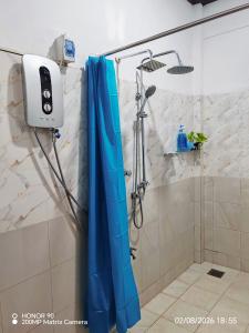 a shower with a blue shower curtain in a bathroom at Villa Keturah in Katunayaka +84 photos