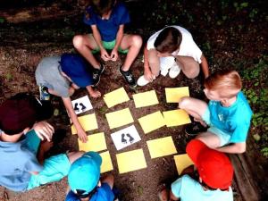 a group of children playing a board game at ZEcamping 4 pet friendly club enfant piscine bar et restanrant in La Bastide-de-Sérou