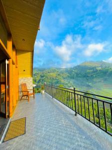 a balcony of a house with a view of the mountains at Paddy Breeze Cabana Ella in Ella