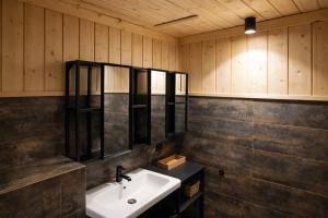 a bathroom with a sink and a mirror at Apartamenty Leśna Przystań nad jeziorem in Węgorzewo +39 photos