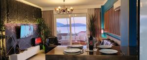 a dining room with a table with plates on it at Eye Luxury Penthouse & apartment in Sarandë