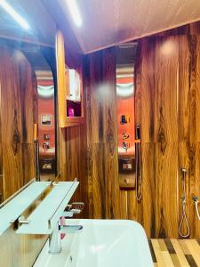 a bathroom with a sink and a mirror at Paddy Breeze Cabana Ella in Ella