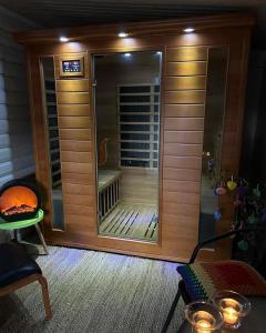 a room with a sauna with a large glass door at Gørding Bed and Breakfast in Gørding