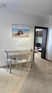 a dining room with a table and chairs and a bedroom at Apart-Hotel Argo in Lozenets