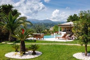 a garden with a pool and a house at Villa Sole Flats in Saint Paul de Vence