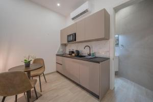 a kitchen with a sink and a table in a room at Urban Vibe 1 in Kirkop