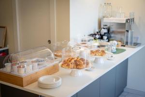 a counter with plates and bowls of food on it at Casale della Vittoria - Guest House in Taranto