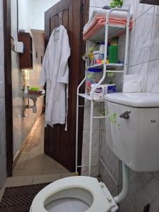 a bathroom with a white toilet in a room at Homey Stay in Kampala +38 photos
