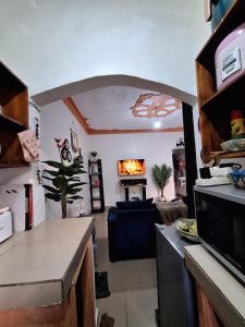 a living room with a couch and a fireplace at Homey Stay in Kampala
