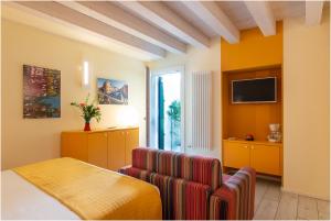 a room with a table and a chair and a television at Tiffany Home in Burano