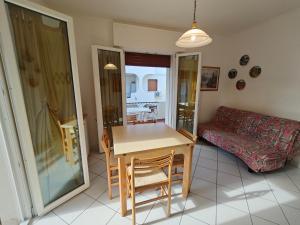 a living room with a table and a couch at Residence Sporting in Rosolina Mare
