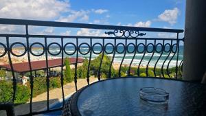 a table on a balcony with a view of the ocean at Apart-Hotel Argo in Lozenets