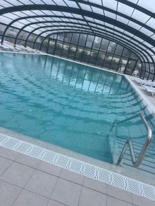 a large swimming pool with a glass ceiling at Mobil Home Litteau Calvados in Litteau