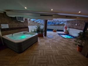 a large bathroom with a tub and a swimming pool at Apartamentos Spa Casco Histórico de Isla in Isla