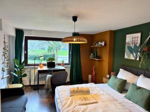 a bedroom with a bed and a desk and a window at Weserblick Hafen-Villa-Bremen in Bremen