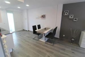 a dining room with a table and black chairs at Cozy Apartment in Vinaròs with Shared Pool in Vinarós