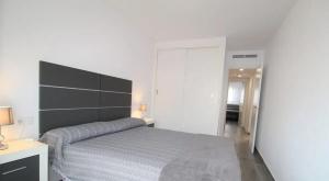 a bedroom with a bed with a large headboard at Cozy Apartment in Vinaròs with Shared Pool in Vinarós +6 photos